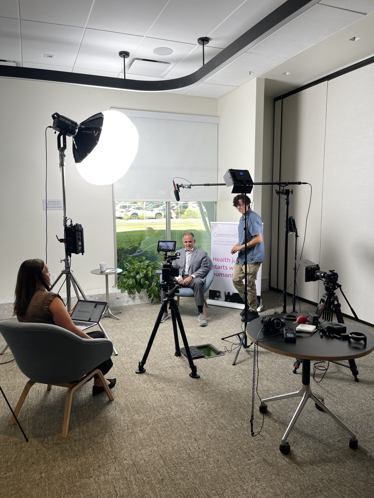 Behind the scenes of the CommonSpirit video shoot — camera, lighting, boom mic and interview setup